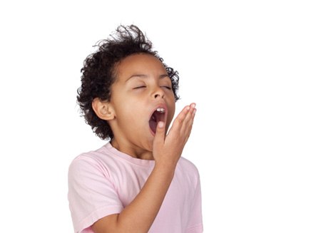 Young boy yawning due to airway issues 