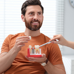 a patient and their dentist talking about dental implants