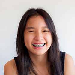 Teen girl with traditional braces smiling