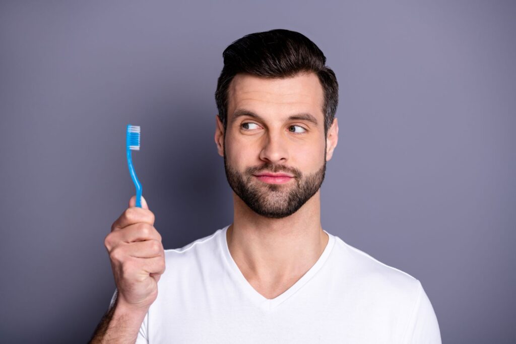 A man holding a toothbrush.