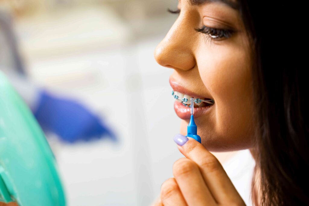 Woman cleaning her braces